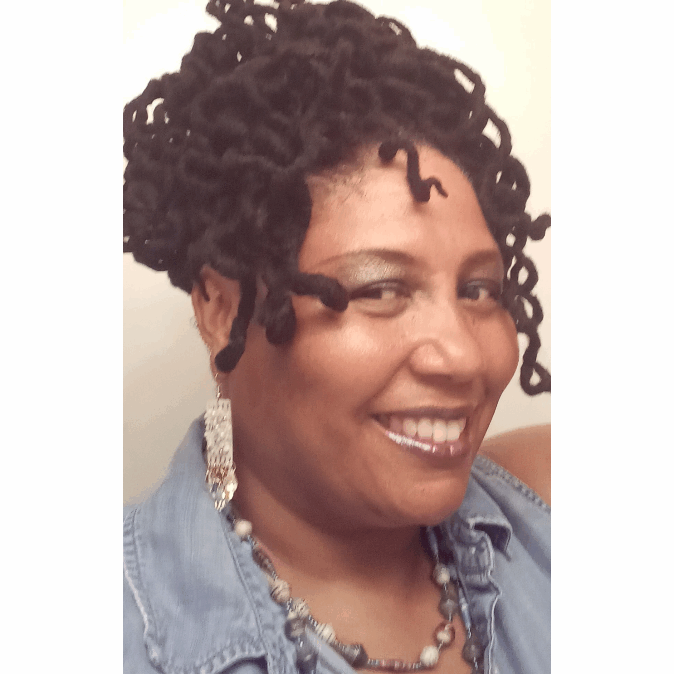 Smiling woman with curly updo hairstyle.