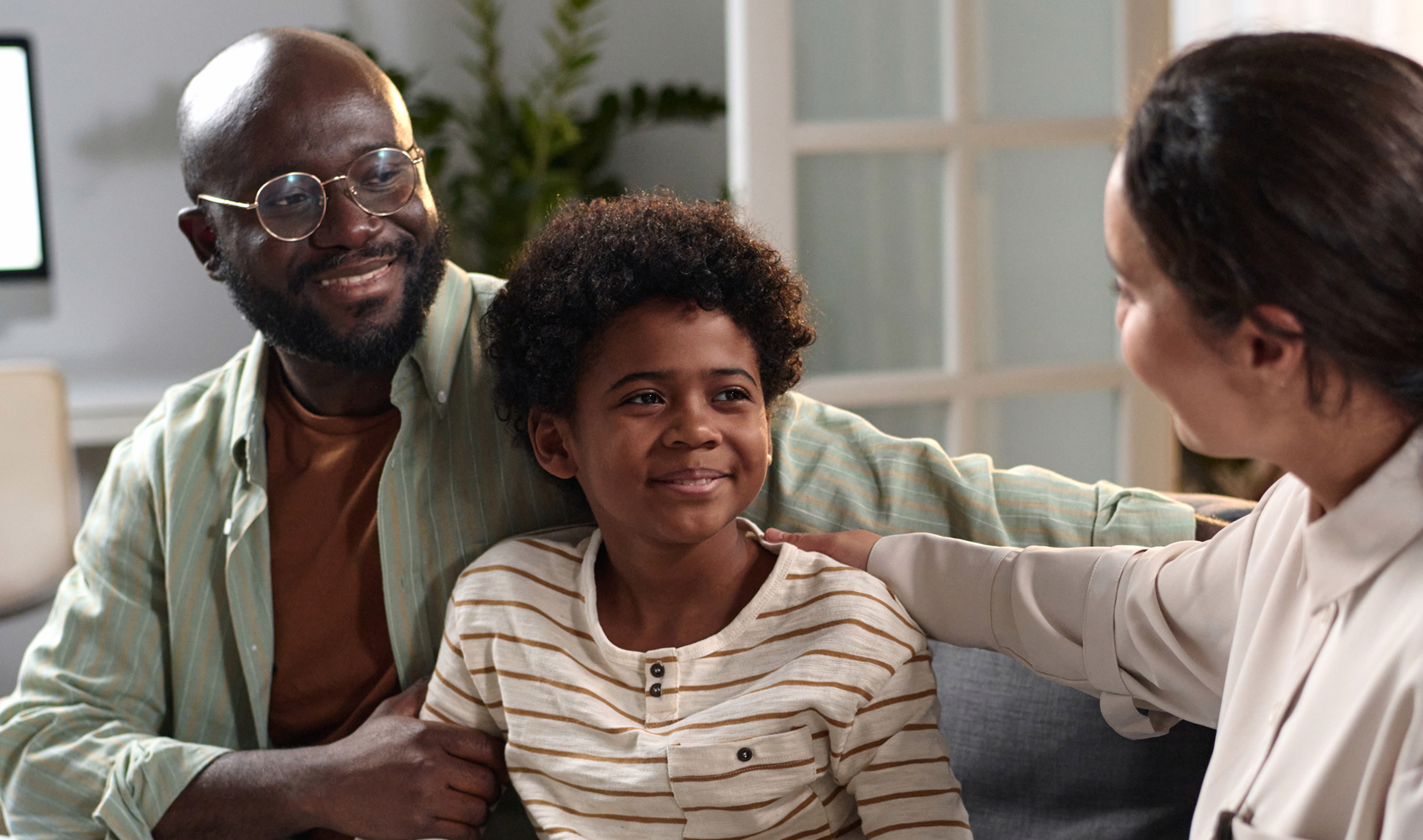 Family sitting together, smiling and talking.